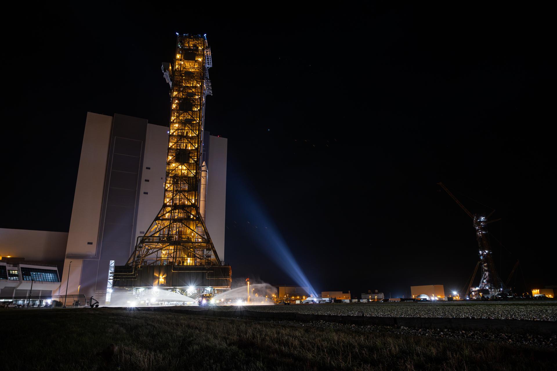 This image shows NASA’s SLS (Space Launch System) and Orion spacecraft rolling out of the Vehicle Assembly Building at NASA’s Kennedy Space Center. NASA's massive Crawler-Transporter, upgraded for the Artemis program, carries the powerful SLS rocket and Orion spacecraft on the Mobile Launcher from the Vehicle Assembly Building to Launch Pad 39B at Kennedy Space Center in preparation for the Artemis II mission.